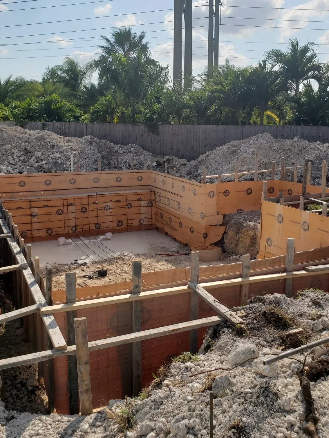 Steel sheet pile shoring with wooden bracing and excavated foundation pit