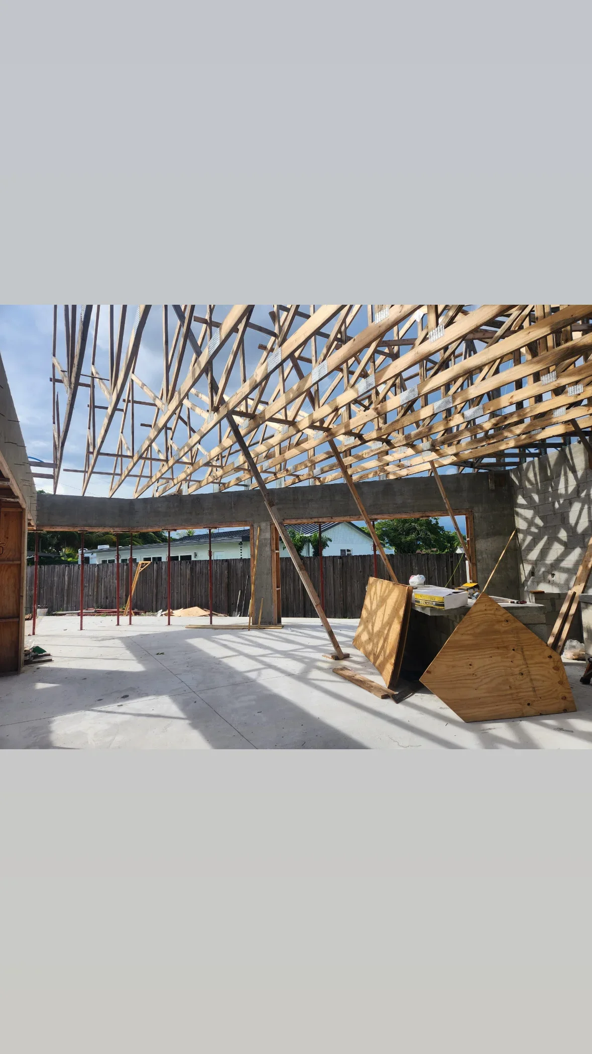 Wood roof trusses and concrete foundation walls on commercial building frame