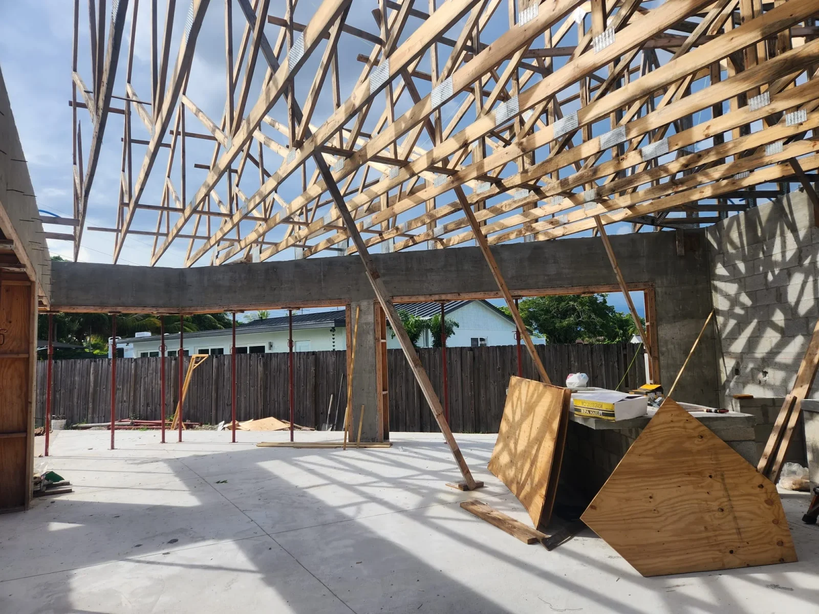 Wooden roof framing with trusses over concrete foundation and block walls during construction